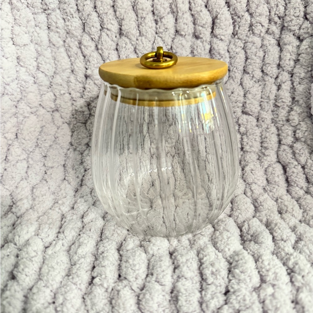 Glass Jar with Wood and gold accent lid.